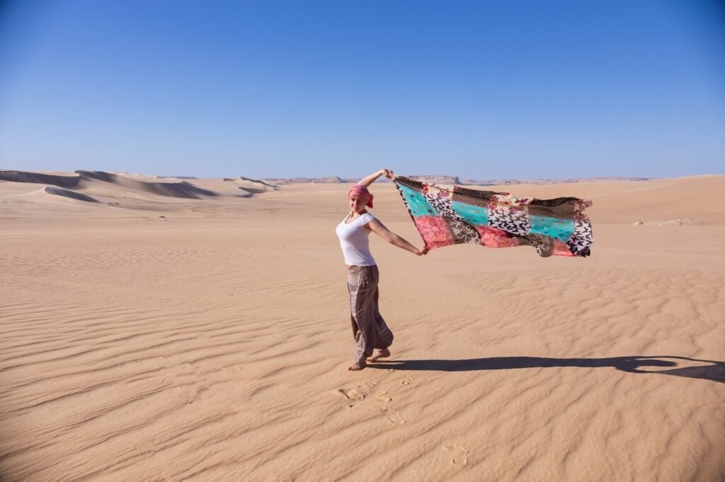 Morocco private tour with driver in Sahara Desert near Merzouga with luxury van and sand dunes at sunset
